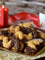 Christmas decorated cookies on a plate with lighted candle