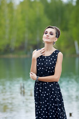 beautiful retro woman in vintage clothes at the lake