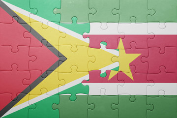 puzzle with the national flag of suriname and guyana