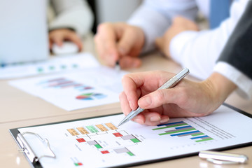 Business colleagues working and analyzing financial figures on a