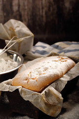 Homemade pound cake with powdered sugar in baking mold