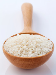 Fototapeta na wymiar Japanese rice, the short rice used for sushi in wooden spoon wit