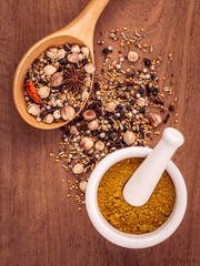 Assorted of spices  in wooden spoon  black pepper ,white pepper,