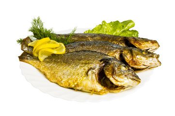 grilled fish with greens on the plate, isolated