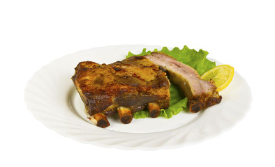 The ribs of wild boar grill on the plate, isolated