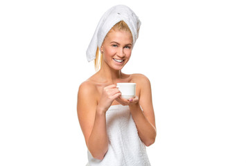 Young attractive woman in towel holding a cup