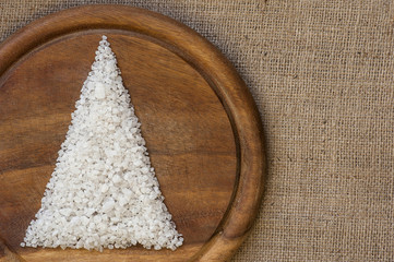 Christmas tree on wooden cutting board and sack background