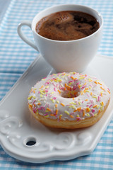 Donut and coffee on a chopping board