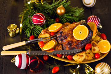 Christmas baked duck served with potatoes, orange and tomatoes