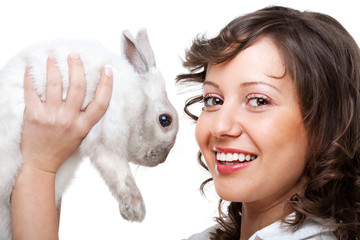 Young woman kissing rabbit