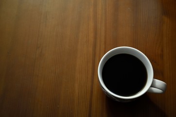 Coffee cup top view on wooden table background
