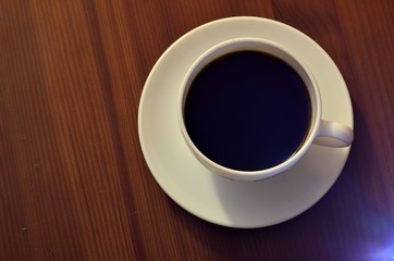 Coffee cup top view on wooden table background
