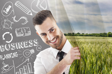 young businessman move a curtain with natural landscape that cov