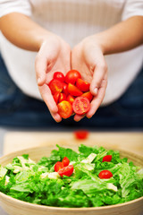 Young woman making salad