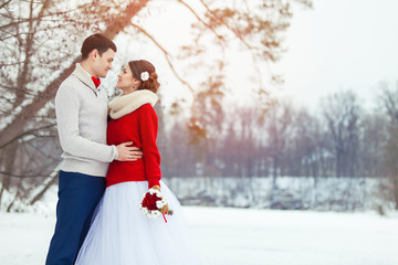 Bride and groom in winter forest