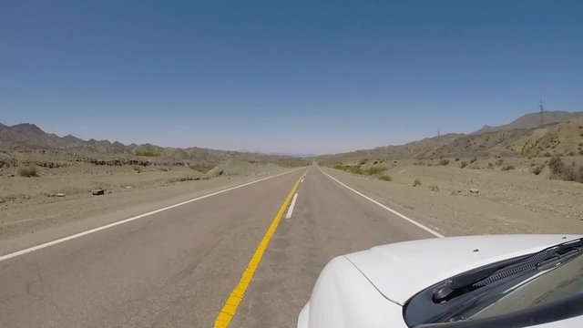 Driving the famous Ruta 40 (Route 40) paved road parallel to the Andes against a blue sky and going to El Leoncito National Park, San Juan Province. Argentina 2014 (Selective focus)