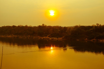 Fototapeta na wymiar Yellow sunset in the Mekong river