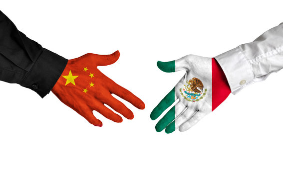 China and Mexico leaders shaking hands on a deal agreement