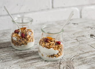 Homemade granola and natural yoghurt on a light wooden surface. Healthy food, healthy Breakfast or snack