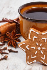 Fresh gingerbread, cup of coffee and spices on old wooden background, christmas time