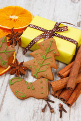 Gingerbread with spices and gifts for Christmas on old wooden background, christmas time