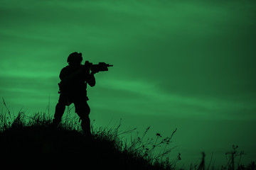 Fototapeta na wymiar Silhouette of soldier with rifle..
