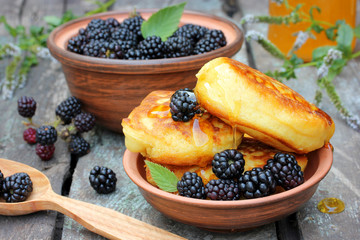 Fluffy pancakes with fresh blackberries and honey