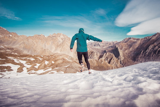 Man running on the snow on a mountain