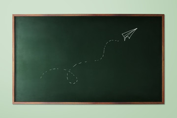 hand-drawn paper plane fly on chalkboard background