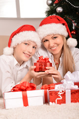 Fototapeta na wymiar mom and son in santa hats