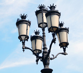 Fototapeta na wymiar Glass street lanterns against blue sky