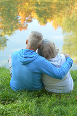 Senior couple sitting near lake