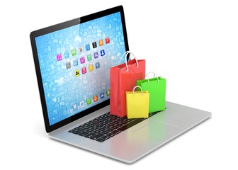 laptop and  shopping pags on white background
