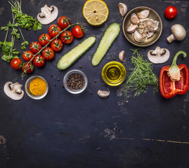 Fototapeta na wymiar Ingredients for cooking vegetarian food tomatoes on a branch, herbs, cucumber, lemon, garlic, oil, black pepper, paprika, mushrooms, border ,with text area on wooden rustic background top view