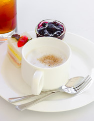 coffee with sandwich ham bread and blue berry cheese cake on white dish