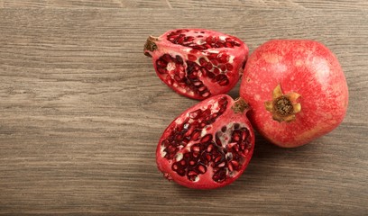 Juicy pomegranate fruit on wooden background