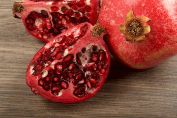 Juicy pomegranate fruit on wooden background
