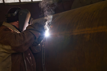 welder performs welding large diameter pipe