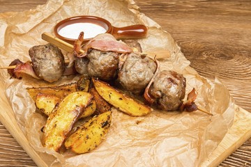 Meat ball and potato with  sauce on wooden table.
