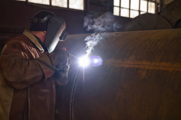 welder performs welding large diameter pipe