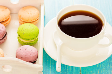 Set of various colored macaroons on wooden plate