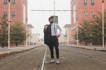 Handsome Indian man posing in an urban context