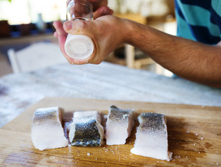 Man seasoning zander fillets