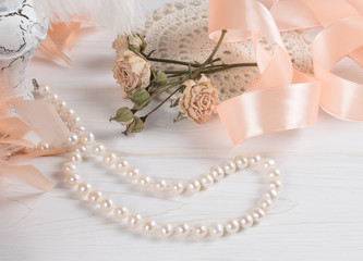 Women's retro accessories including pearl necklace and silk ribbon