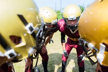 Foto op Plexiglas American Football players at strategy huddle © Kzenon