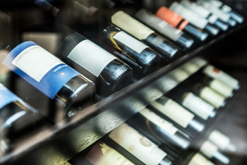 Bottles of wine on the wooden shelf.