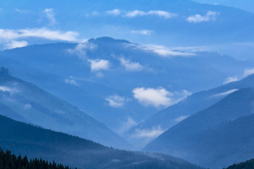 Fototapeta na wymiar mountain backbone silhouette in a blue mist