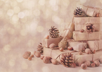 Fototapeta na wymiar Christmas card. Christmas gifts, nuts and fir cones. Vintage st