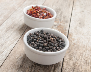 Black pepper on wood background