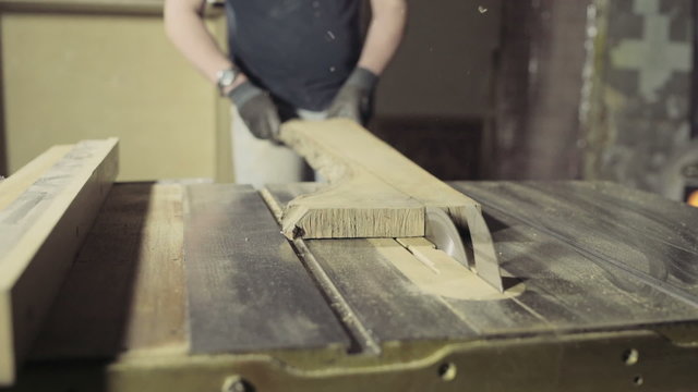 joiner cut a wooden plank with circular Saw slow motion